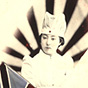 An Asian female nurse holding both the British and Japanese flags.