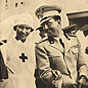 A White female nurse (Princess Maria Josè) arm in arm with a White male soldier.