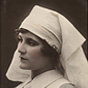 A White woman (Violet Hopson) dressed as a nurse, looking to the left.