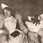 A White female nurse asleep in chair next to sleeping White female patient in bed.