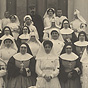 Large group of White nun nurses and doctors in front of a hospital.