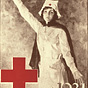 A White female nurse in white raises her arm and looks at the viewer.