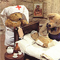 A teddy bear doll dressed as a nurse in white stands by a bear doctor as they examine a bear patient.