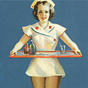 A White female nurses in short white dress holding a tray, in the style of a pin-up girl.