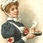A White female nurse in blue and white, holds a tray with a steam beverage on it.