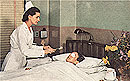 White female nurse treating a White female eye patient, lying in bed.