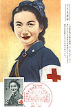 A Japanese Red Cross nurse in blue uniform, looking at the viewer.