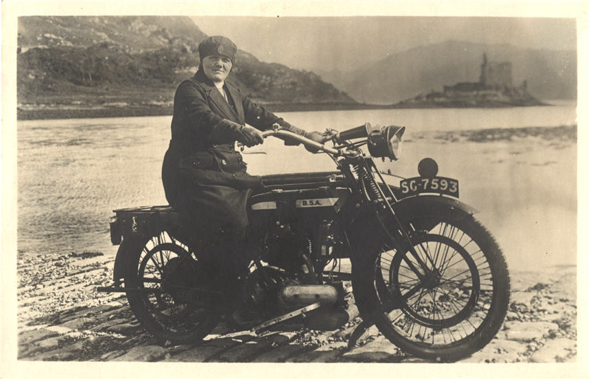 A White female nurse on a motorcycle, looking at the viewer, castle in background