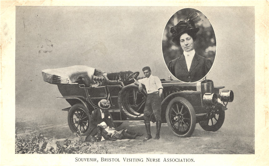 A White female nurse tending to a White boy in front of a car, White male leans against the car.
