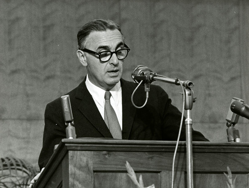 A white man speaking at a podium