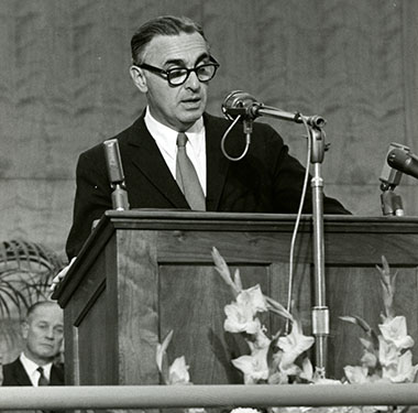 A white man speaking at a podium