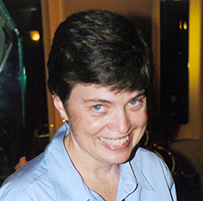 Dr. Jean R. Anderson, a White female wearing a bolero with a blue button down shirt.