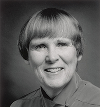Dr. Barbara Bates, a White female with short hair smiling for her portrait.