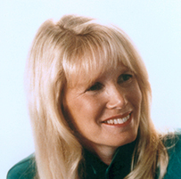 Dr. Susan J. Blumenthal, a smiling White female with blonde hair posing in green professional attire.