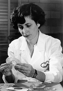 Dr. Nina Starr Braunnwald, a White female in a lab coat working with a round disk and wires.