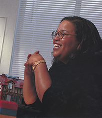 Dr. U. Diane Buckingham, a smiling African American female with her hands folded in front of her.