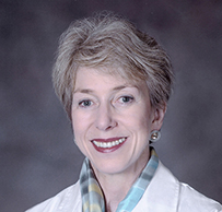 Dr. Christine Karen Cassel, a smiling White female in a white lab coat posing for her portrait.