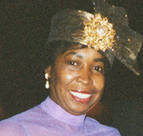 Dr. Sadye Beatryce Curry, an African American female in a floor-length purple gown and gold headpiece.