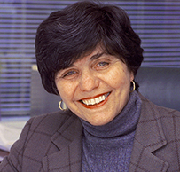 Dr. Catherine D. DeAngelis, a smiling White female in a suit jacket seated in an office.