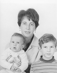 Dr. Katherine M. Detre, a White female posing with her two children for a portrait.