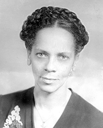Dr. Lena Frances Edwards, an African American female with a braid across her crown posing for her portrait.