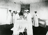 Dr. Matilda Arabella Evans, an African American female in scrubs in the operating room of Taylor Lane Hospital, the hospital she founded in 1901.