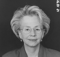 Dr. Denise L. Faustman, a White female in a collared blouse and glasses posing for her portrait.