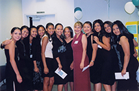 Dr. Katherine A. Flores, a White female, center, in a red dress, posing with a group of women.