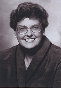 Dr. Nancy E. Gary, a smiling female with short hair and glasses posing for her portrait.