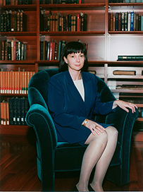 Dr. Nunzia Bettinsoli Giuse, a White female in a blue suit sitting in a room with bookshelves.