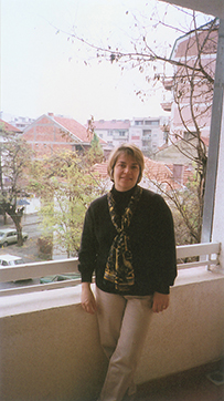 Dr. Maria Isabel Herran, a White female standing on a balcony outdoors.