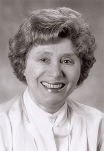 Dr. Ruth L. Kirschstein, a smiling female in blouse posing for her portrait.