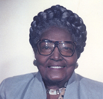 Dr. Agnes D. Lattimer, a smiling African American female with glasses and in a suit posing for her portrait.