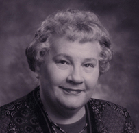 Dr. Carol M. Newton, a White female in a dark suit jacket posing for her portrait.