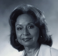 Dr. Vivian W. Pinn, a smiling female with dark hair in a suit posing for her portrait.