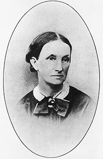 Dr. Ann Preston, a female in a bow necktie posing for her portrait.