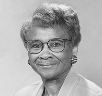 Dr. Clarice D. Reid, an African American female in a suit jacket and glasses posing for her portrait.
