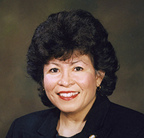 Dr. Elena V. Rios, a smiling White female with dark hair in a suit posing for her portrait.