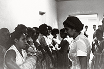 Dr. Helen Rodriguez-Trias, a Latina female (on the right) facing a crowd of mothers.