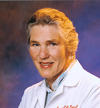 Dr. Janet Davison Rowley, a White female in a lab coat posing with her arms crossed for her portrait.