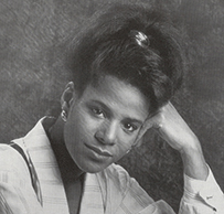 Dr. Debi Thomas, an African American female in professional attire posing for her portrait.