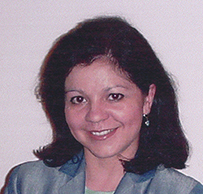 Dr. Ileana Vargas-Rodriquez, a Latina female in a suit with her arms crossed, smiling for her portrait.