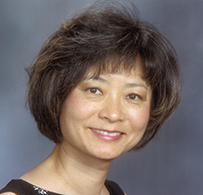 Dr. Rebekah May Wang-Cheng, an Asian female with short hair smiling for her portrait