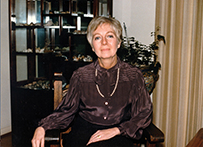 Dr. Marjorie Price Wilson, a White female in a brown silk blouse seated in a room for a photo.