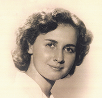 Dr. Norma Spielman Wohl, a White female with curly hair smiling for her portrait.