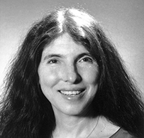Dr. Stephanie Joan Woolhandler, a White female with long dark hair smiling for her portrait.