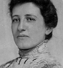 Dr. Susan Emma Hertz Howard, a female with dark hair pulled back in a formal blouse posing for her portrait.