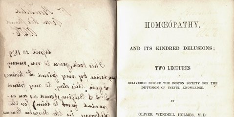 Open to show the title page of Homeopathy, and its kindred delusions by Oliver Wendell Holmes and the bleed-through of a letter opposite of the title page.