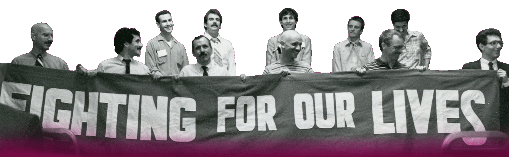 Un grupo de once hombres sostienen una pendón con letras blancas que dice “Luchamos por nuestra vida”.