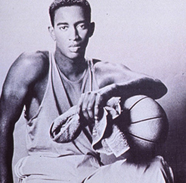 A portrait of an African American man holding a basketball